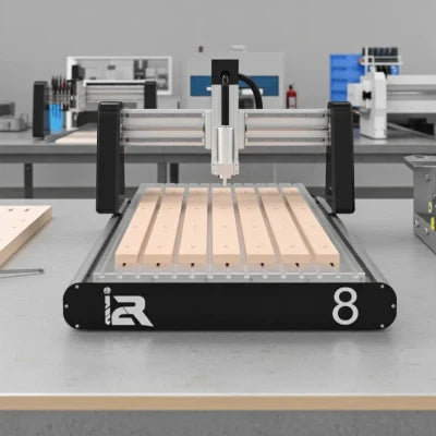 i2R-8 Desktop CNC Router machine with wood pieces on the aluminum T-track table in a workshop
